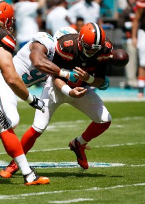 Cleveland Browns quarterback Cody Kessler (6) funnels the ball after he was sacked by Miami Dolphins defensive end Cameron Wake (91) during an NFL football game, Sunday, Sept. 25, 2016, in Miami Gardens, Fla. (AP Photo/Wilfredo Lee)